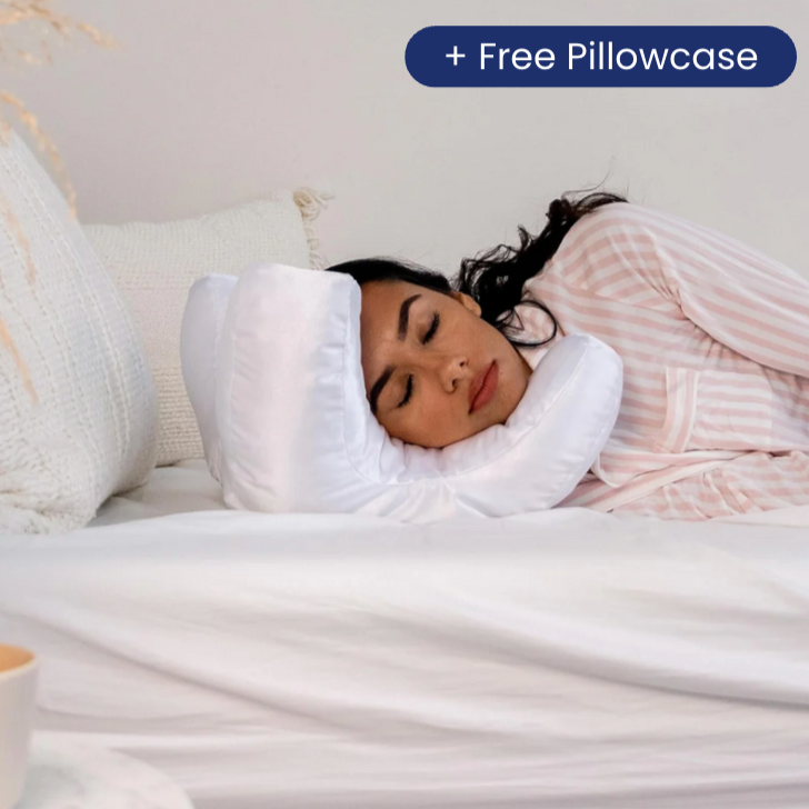Woman sleeping comfortably using getblissyneck Beauty Sleep Pillow with free pillowcase on white bed