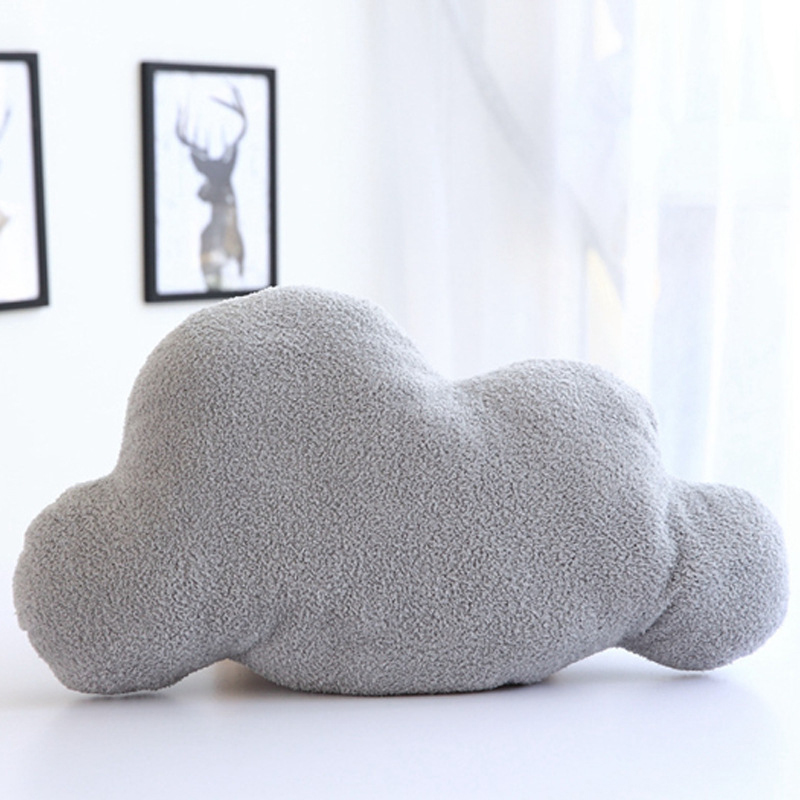 Gray cloud-shaped throw pillow with soft textured fabric from getblissyneck on white background