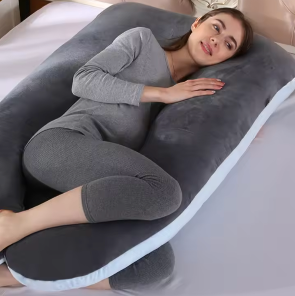 Woman lying comfortably on a gray and white Pregnancy Body Pillow by getblissyneck on a bed