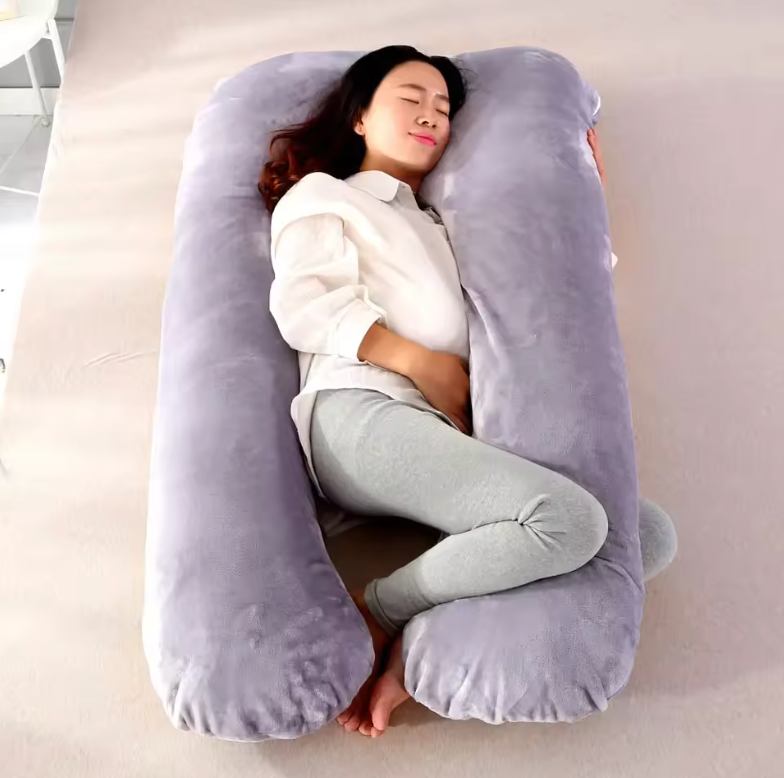 Pregnant woman resting comfortably on a large gray Pregnancy Body Pillow by getblissyneck