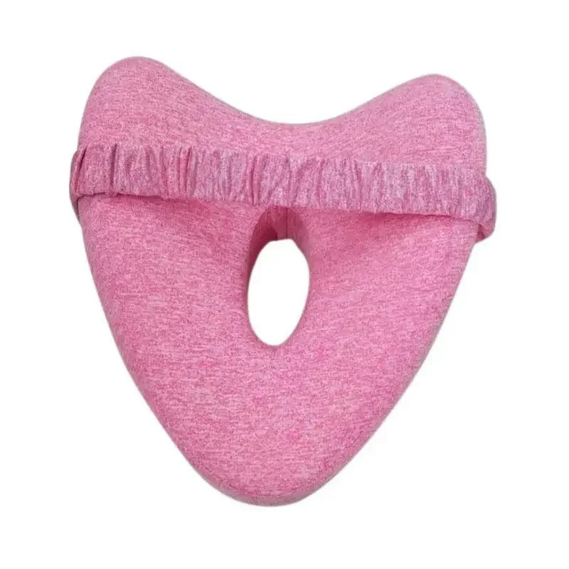 Pink leg pillow for side sleepers with soft fabric and ergonomic cutout for comfort