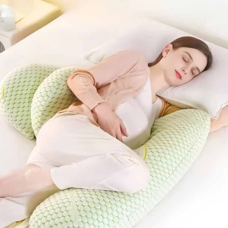 Pregnant woman sleeping comfortably on bed using a Premium Pregnancy Pillow with soft textured cover