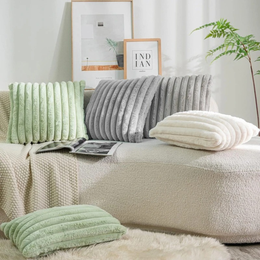 Cozy living room setup featuring a grey throw pillow grey case with textured stripes on a neutral sofa