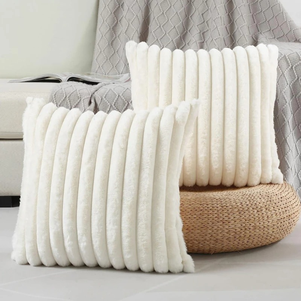 Soft textured throw pillow white case with vertical ribbed design in cozy living room setting
