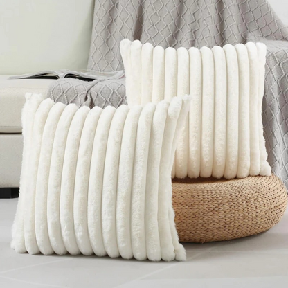 Soft textured throw pillow white case with vertical ribbed design in cozy living room setting